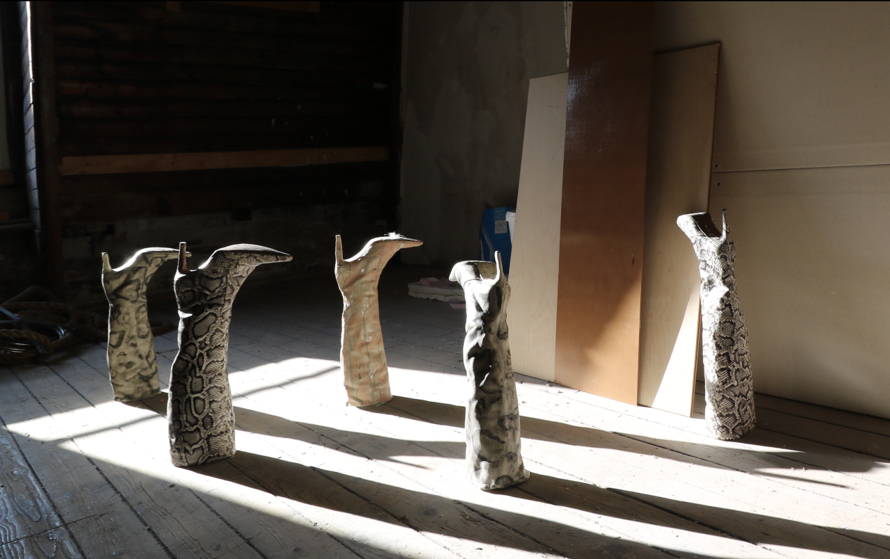 G, ‘TRICK YOURSELF DARLING’ - 2025, ceramic, glaze, faux snakeskin, aluminum knife & fork, sheep hair and plaster